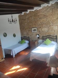 a bedroom with two beds and a brick wall at Villa los gavilanes in Santa Cruz de Tenerife