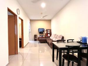 a living room with a couch and a table at VGO House in Malacca