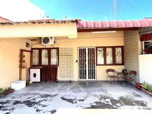a house with a front door and a patio at VGO House in Malacca