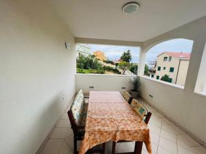 a dining room with a table and chairs and a window at Villa Tajnikov in Hvar