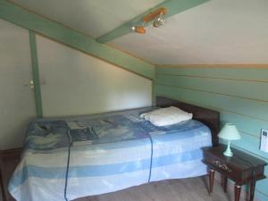a bedroom with a bed and a table with a lamp at Hope's Land - gîte in Onesse-et-Laharie