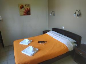 a hotel room with a bed with towels on it at GIOTAS APARTMENTS - STUDIOS in Argalasti