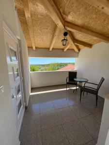 a room with a table and chairs and a window at Guest Accommodation Grozdanić in Dubravice