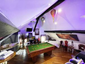 a living room with a pool table in it at Chambre & Lounge Privé Jacuzzi in Marolles-en-Hurepoix