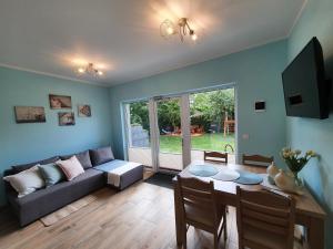 a living room with a couch and a table at Domki Apartamentowe 3Fale in Władysławowo