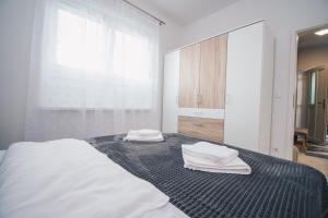 Postel nebo postele na pokoji v ubytování L Apartment + 4 fotografie