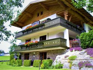 a house with a balcony on top of it at Ferienhaus Hirterhütte in Abtenau