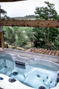 a bath tub sitting on a porch with a window at Nuitées Bohèmes in Gajan