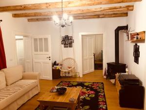 a living room with a couch and a table at Casa bunicilor in Ucea de Jos