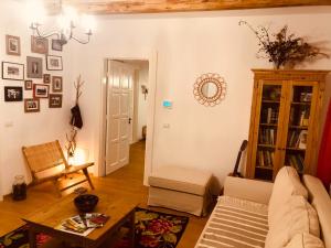 a living room with a couch and a table at Casa bunicilor in Ucea de Jos