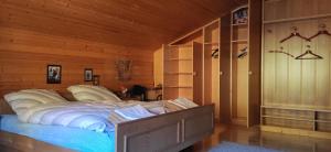a bedroom with a large bed in a wooden room at Villa for a get away in Soprabolzano