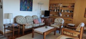 a living room with a couch and two chairs and a tv at Villa for a get away in Soprabolzano