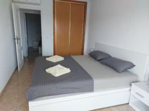 1 dormitorio con 1 cama con 2 toallas en AQUAMARINA CABO ROIG, en Cabo Roig