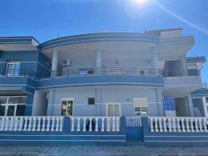 a large blue building with a balcony at Kristeo in Vlorë