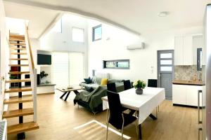 a living room with a white table and a couch at Loft House Zante in Argassi