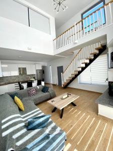 a living room with a couch and a staircase at Loft House Zante in Argassi