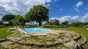 a swimming pool in the middle of a yard at Agriturismo Bio Le Macchie Alte in Manciano