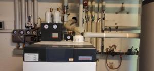 a machine in a room with pipes and valves at Villa for a get away in Soprabolzano