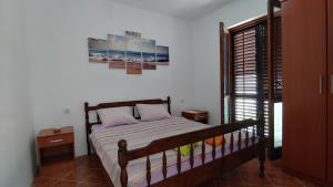 a bedroom with a bed and a picture on the wall at Matovic Apartments in Dobra Voda +18 photos