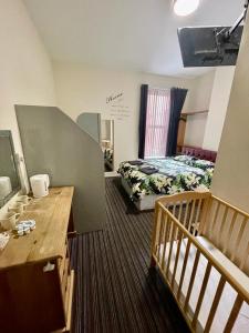 a hotel room with a bed and a staircase at Hayward Hotel in Blackpool