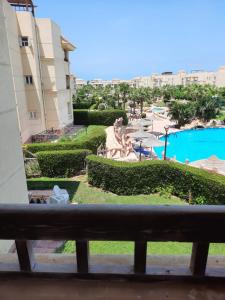 a view from a balcony of a resort with a pool at شاليه قرية مرسيليا بيتش 3 مارسيليا عائلات فقط - Marseilia Beach 3 chalet Families Only in Dawwār Muḩammad Abū Shanab