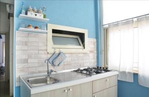 a kitchen with a sink and a stove at Borgata Mazzarelli 2 in Marina di Ragusa +16 photos