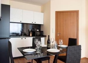 a kitchen with a dining table with wine glasses at Complex Nero in Pamporovo