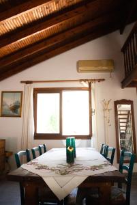 a table and chairs in a room with a window at Agrampeli in Limenaria