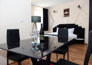 a dining room with a glass table with wine glasses at Complex Nero in Pamporovo