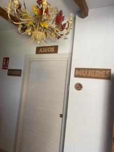 a door in a room with a chandelier above it at El hotel de Verdiago in Verdiago