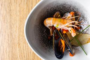 a plate of food with a lobster on a table at Cool Šilo Appartement Resort in Šilo