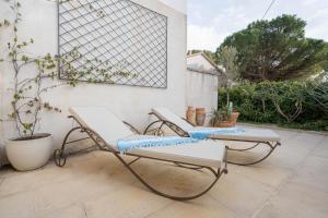two chairs and a table on a patio at Hôtel Le Méditerranée in Hyères