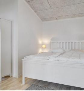 1 dormitorio blanco con cama blanca y techo en Cold Hawaii, en Torsted