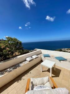 a patio with a view of the ocean on a building at Villa San Gaetano in Pantelleria