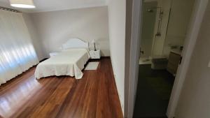 a hospital room with a bed and a bathroom at Casa del Patio in Cangas de Morrazo +22 photos