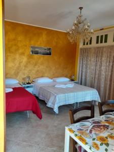 a bedroom with two beds and a table with chairs at B&B Il girasole - A casa di Ale in Oratino