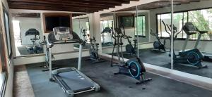 a gym with several treadmills and exercise bikes at Hacienda El Salitre Hotel & Spa in Querétaro