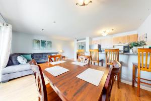 a kitchen and dining room with a wooden table and chairs at Lake Winnipesaukee Retreat in Gilford