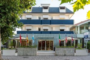 a building with american flags in front of it at Hotel Mare Blu in Francavilla al Mare
