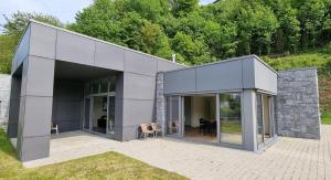 a gray house with glass doors and a patio at PENTHOUSE DURBUY APPART 10-12 Pers Vue Panoramique in Durbuy