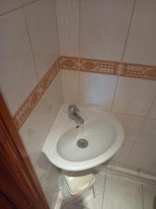 a bathroom with a white sink and a toilet at Yarm cottages the rafters in Kirk Leavington