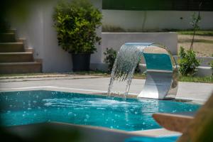 a water fountain in a swimming pool at Delight Luxury Villa in Zakynthos