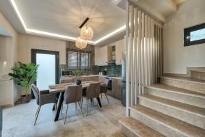 a dining room and kitchen with a table and chairs at Delight Luxury Villa in Zakynthos