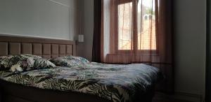 a bed in a bedroom with a window at Astronomiczny apartament , mieszkanie 2 pokojowe. Parking. in Toruń