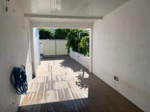 ein leerer Flur eines Hauses mit großem Fenster in der Unterkunft Aroeira Beach House in Aroeira