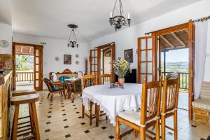 a dining room with a table and chairs at Ourania Apartment in Skopelos Town