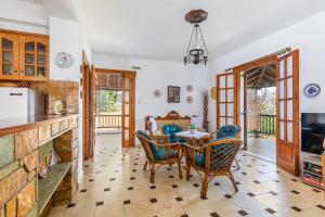 a kitchen and dining room with a table and chairs at Ourania Apartment in Skopelos Town