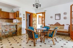 a kitchen and living room with a table and chairs at Ourania Apartment in Skopelos Town