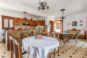 a kitchen and dining room with a table and chairs at Ourania Apartment in Skopelos Town