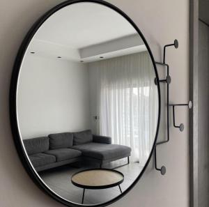 a living room with a couch and a mirror at Luxurious 1 bedroom space in Accra +2 photos